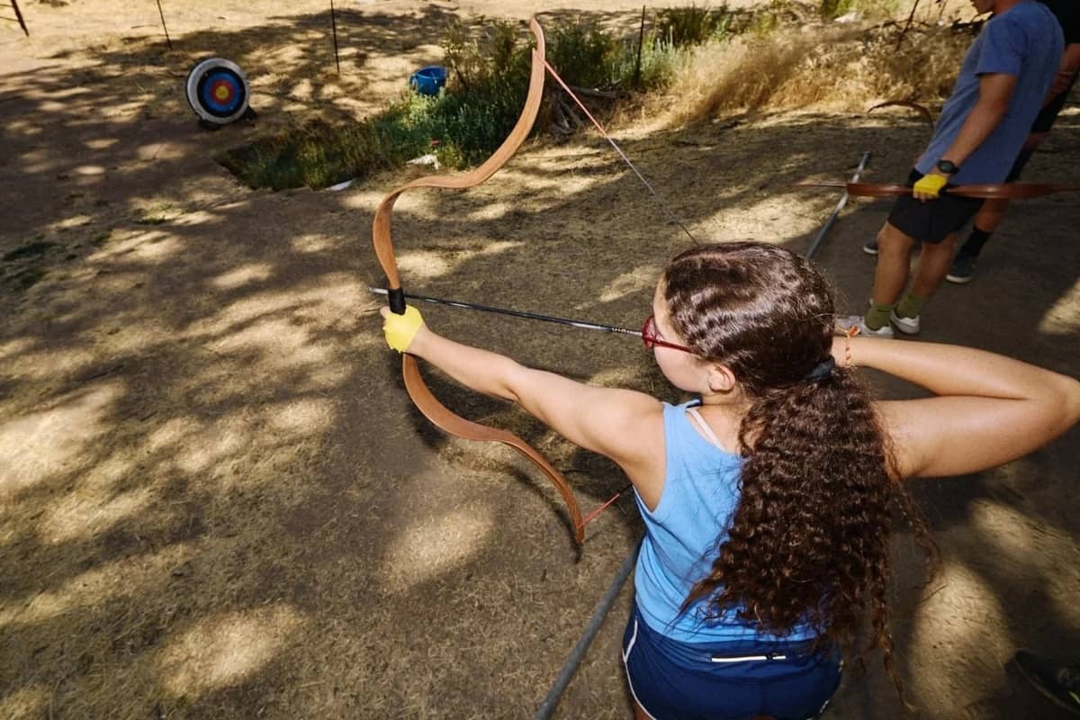 Girl getting ready to shoot a bow and arrow