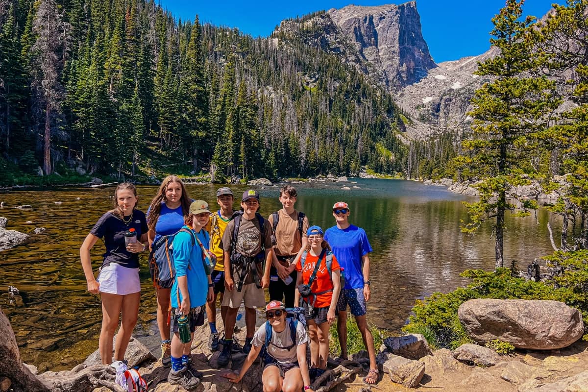 Kids hiking with lake in the background at Bold Earth Colorado