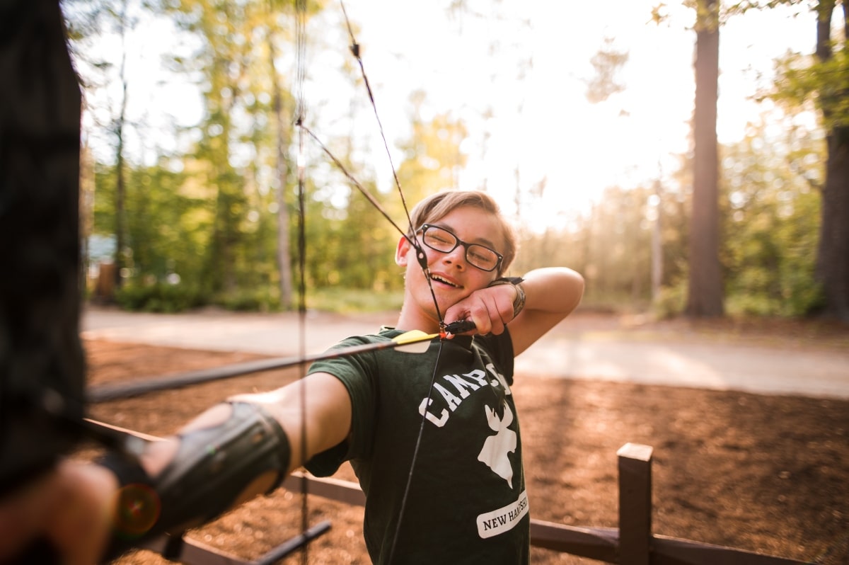 Boy releasing arrow at Camp Cody